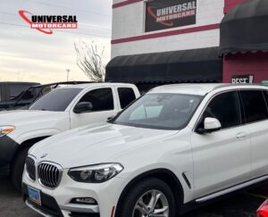 White BMW SUV parked at a dealership, emphasizing luxury vehicle repair and maintenance services.