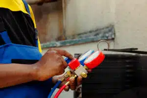 a car mechanic performing for ac repair in Las Vegas garage.