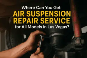 A mechanic's hands work on a car's air suspension. Text asks about air suspension repair services in Las Vegas. Tone is informative and professional.
