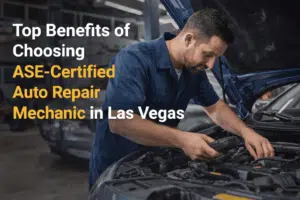 A mechanic works on a car engine in a garage, promoting the benefits of choosing ASE-certified auto repair services in Las Vegas.