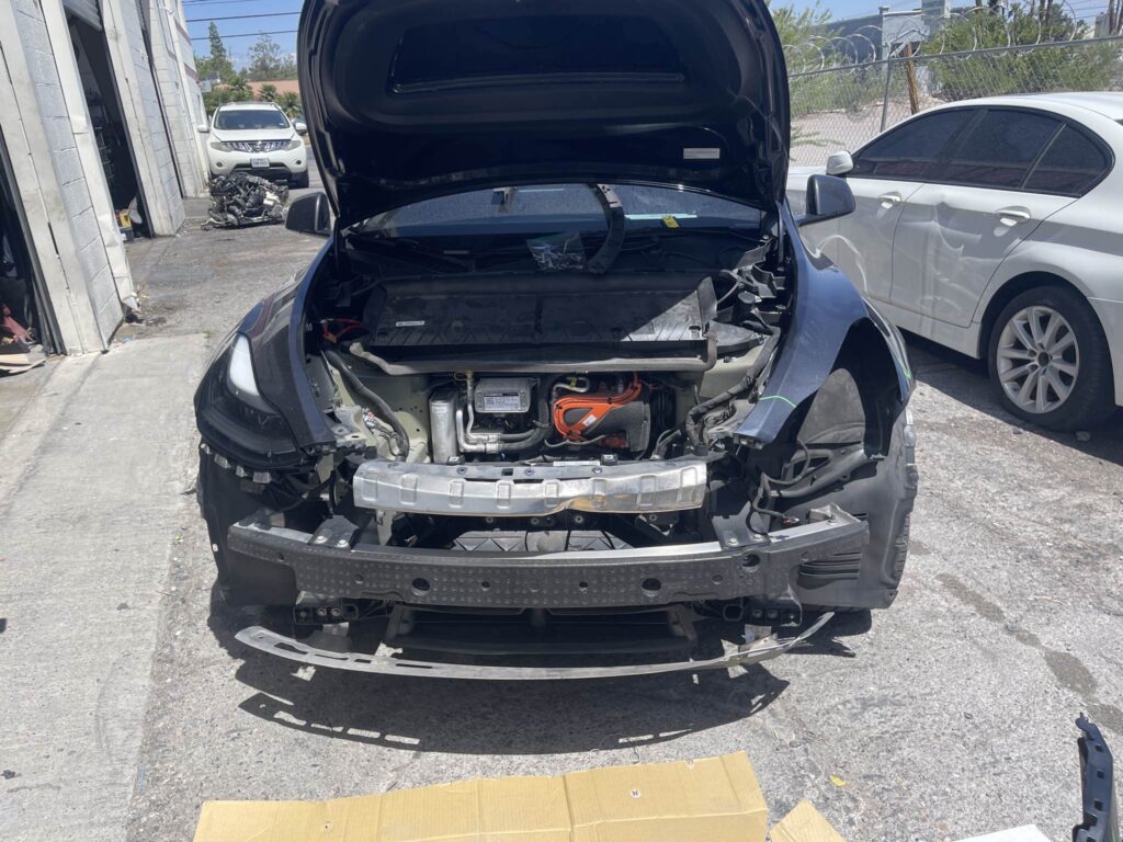 2024 Tesla Model Y with the front bumper removed for collision damage inspection in Las Vegas