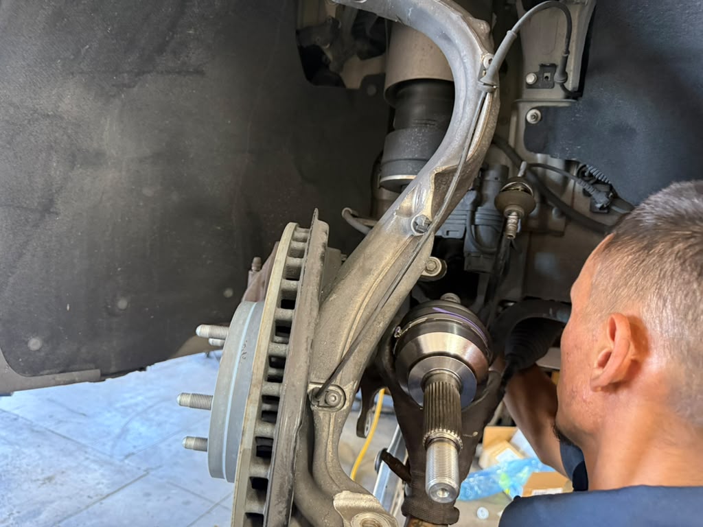 Tesla suspension and brake repair with wheel removed at Universal Motorcars in Las Vegas