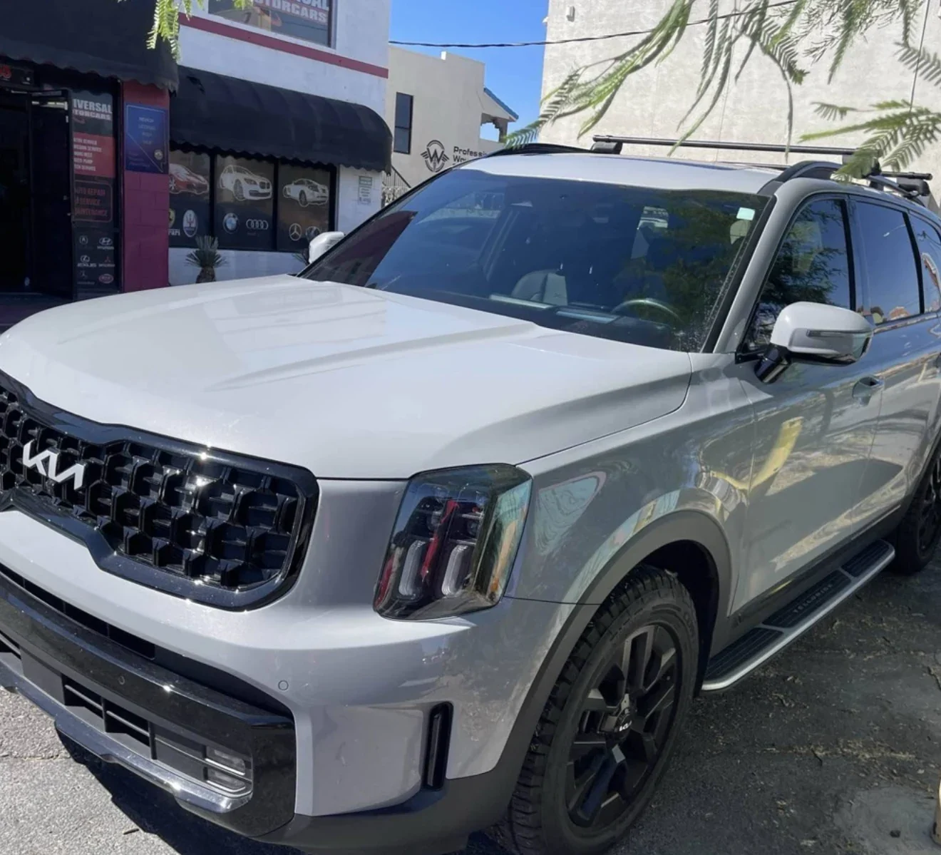 White Kia Telluride outside Universal Motorcars on Spring Mountain Road in Las Vegas