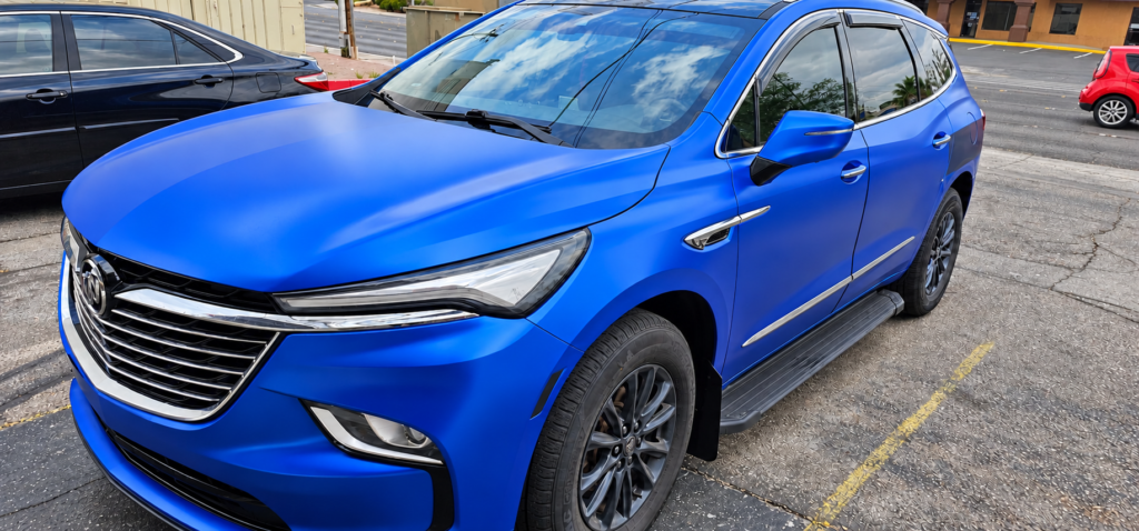 Front three-quarter view of a blue Buick Enclave at Universal Motorcars in Las Vegas