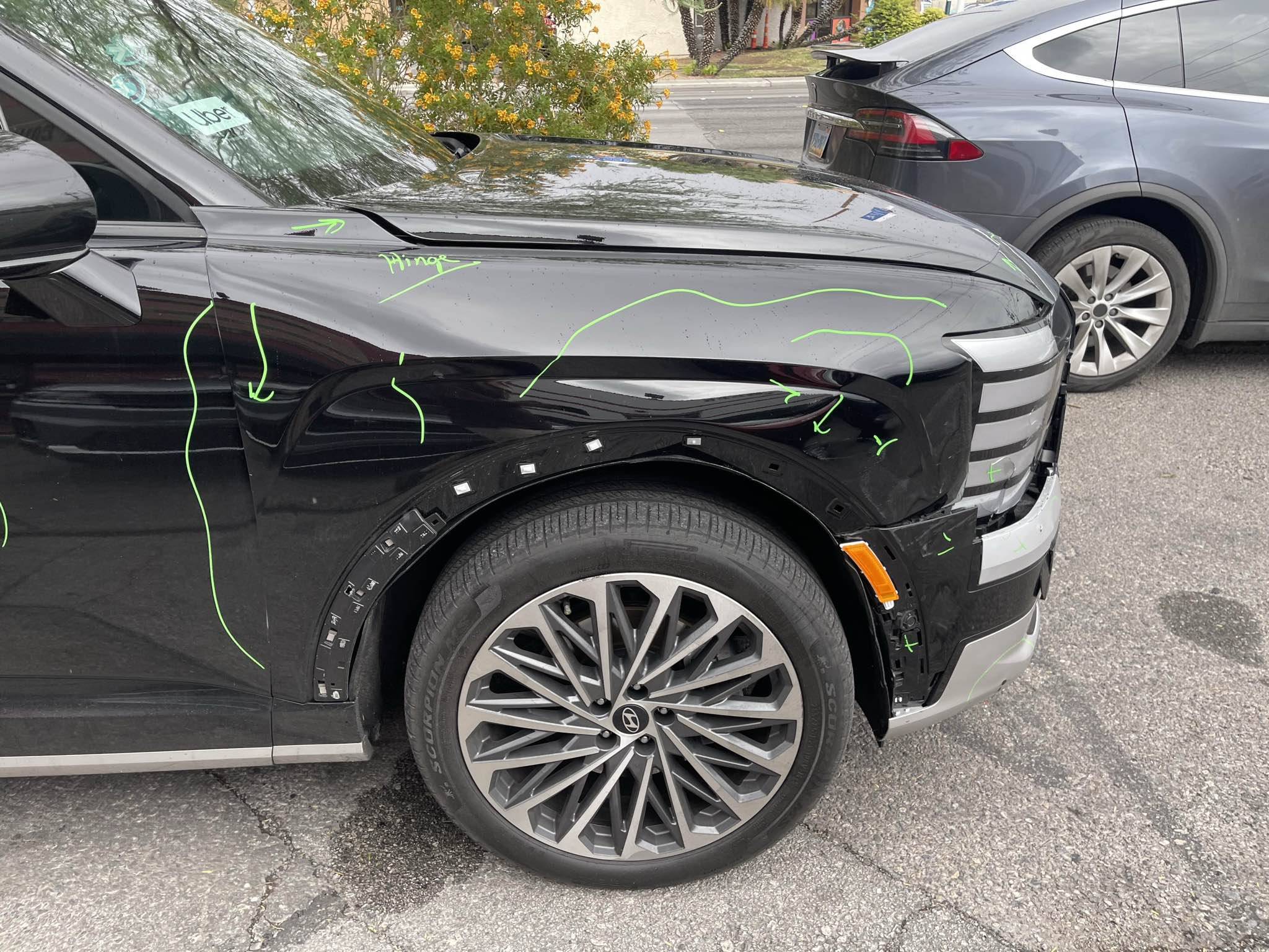 Close-up of Hyundai Palisade front-corner damage with green repair-planning marks at Universal Motorcars