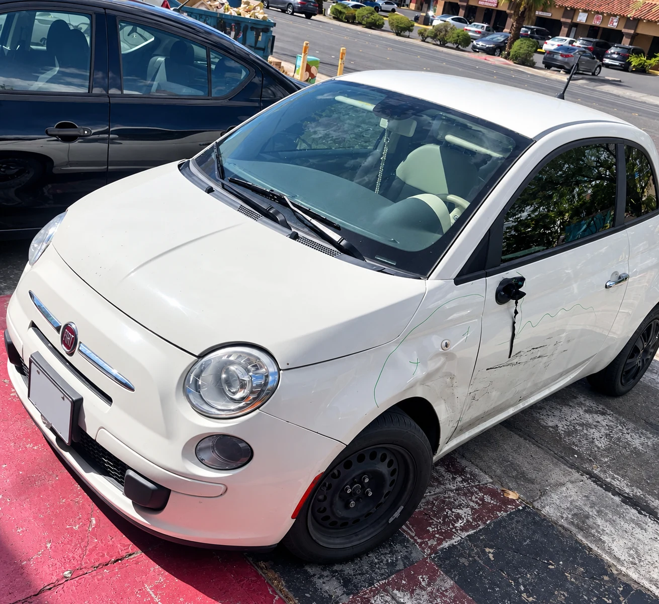 Fiat 500 with door and fender collision damage at Universal Motorcars in Las Vegas