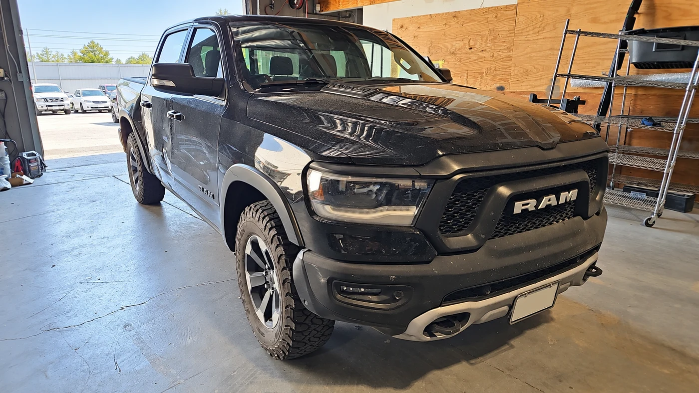 Black Ram pickup in the Universal Motorcars workshop, with license plate information removed