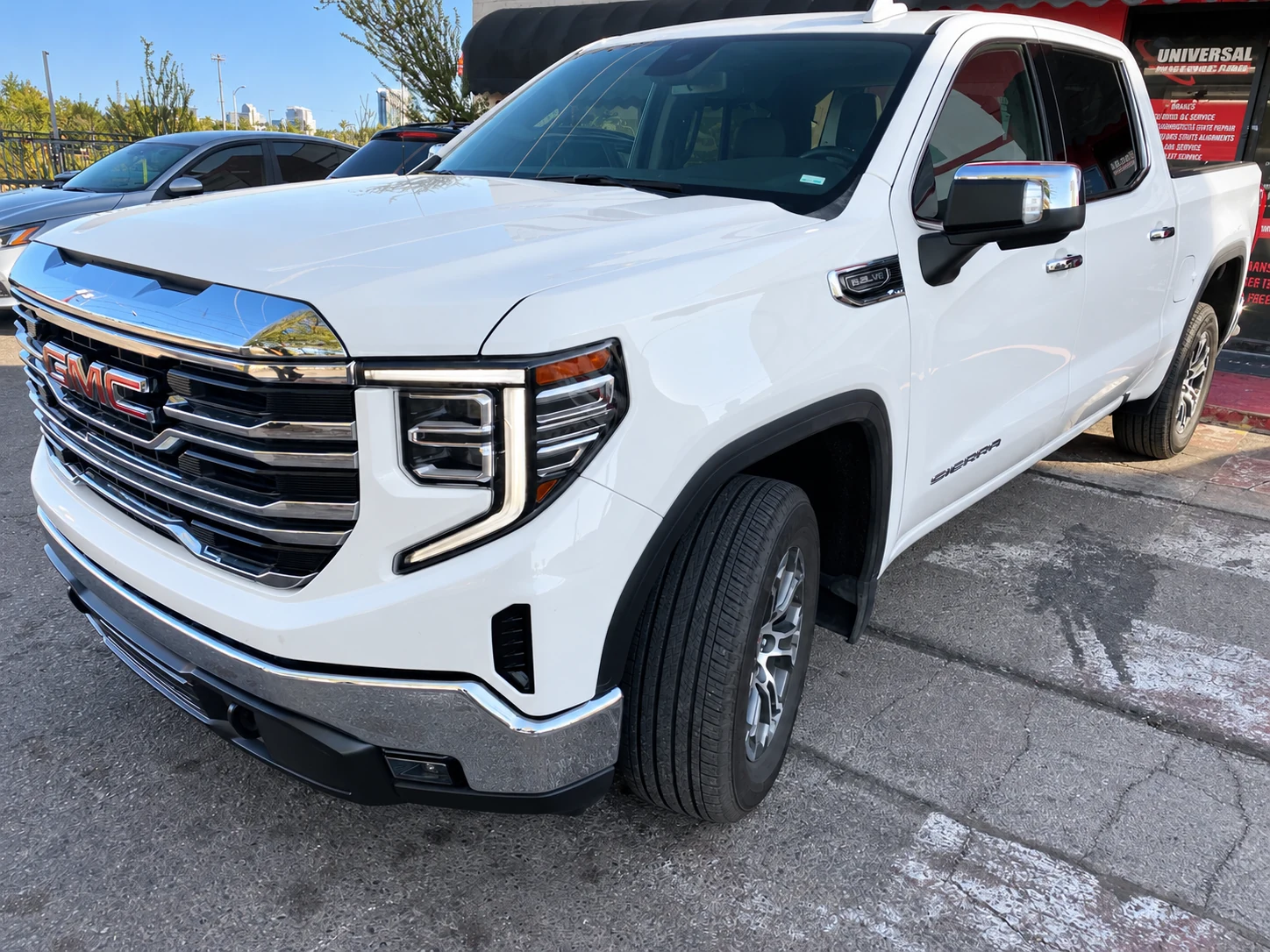 White GMC Sierra pickup outside Universal Motorcars in Las Vegas