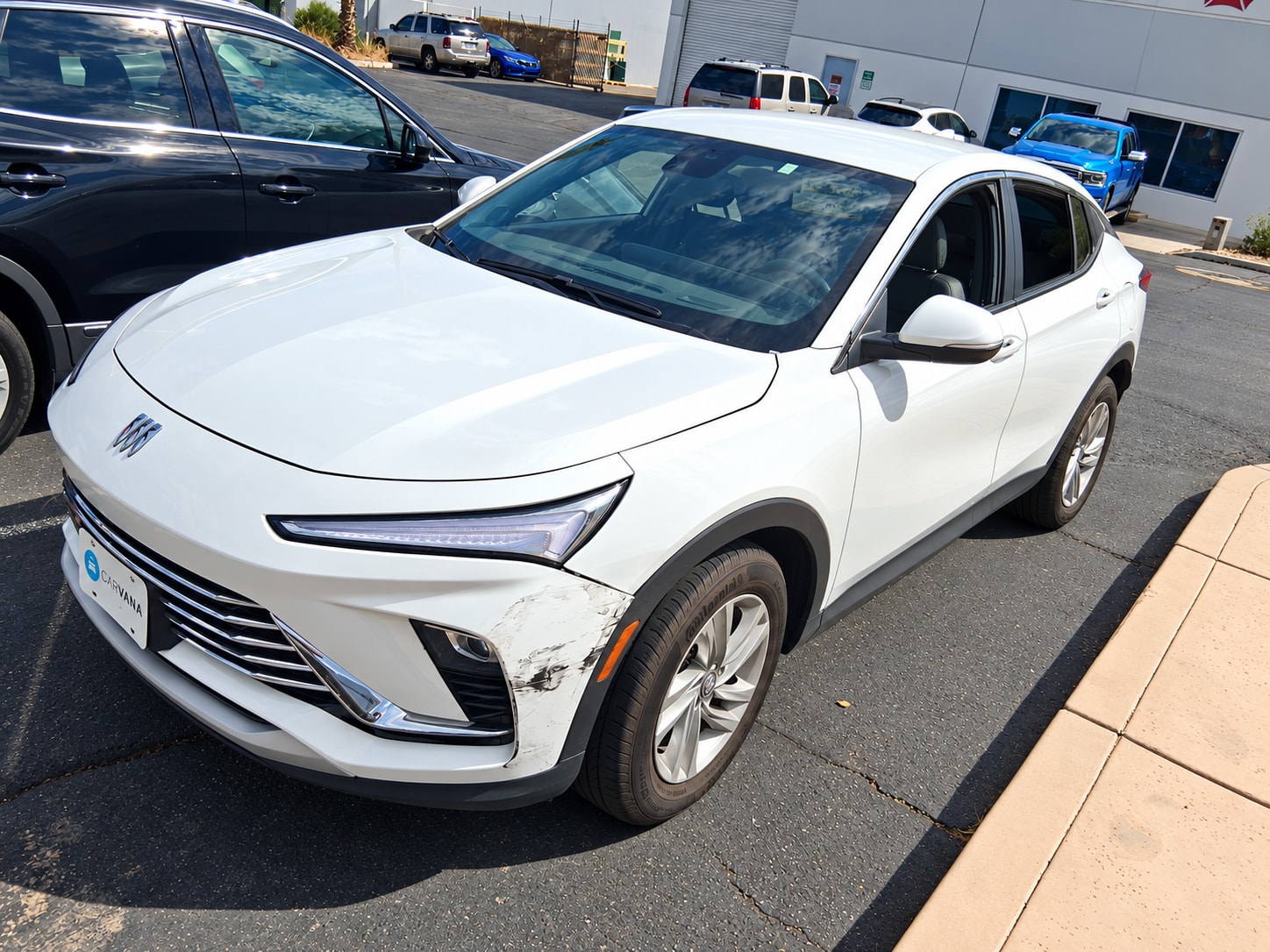 Front bumper scuffs on a white Buick at Universal Motorcars in Las Vegas