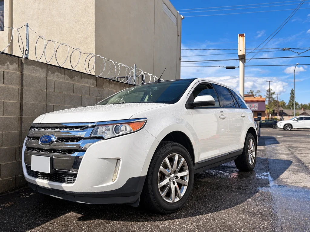 White Ford Edge viewed from the front and driver’s side