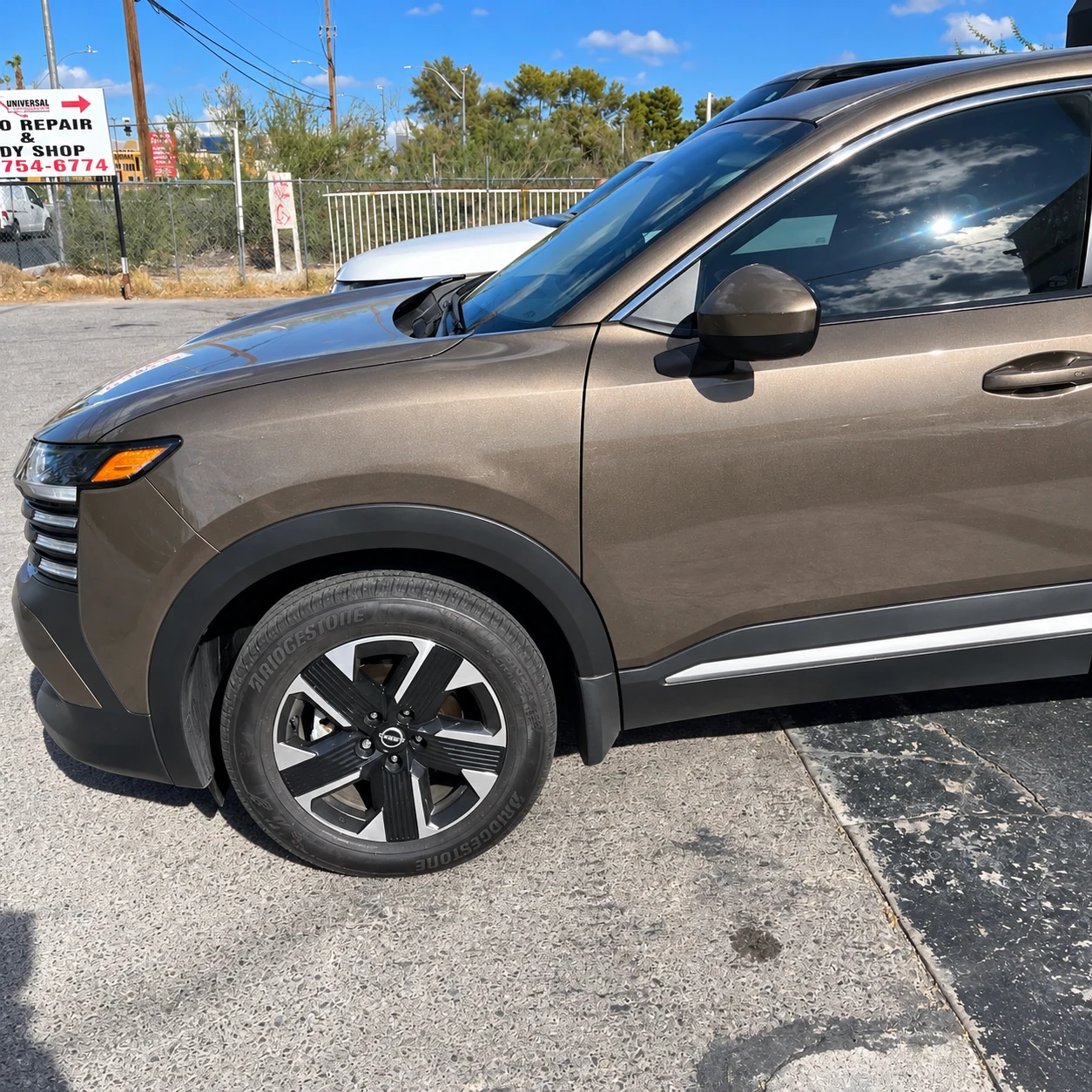 Bronze Nissan front fender and driver’s door.