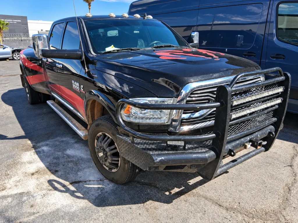 Black RAM 3500 with a brush guard and aftermarket wheels at Universal Motorcars
