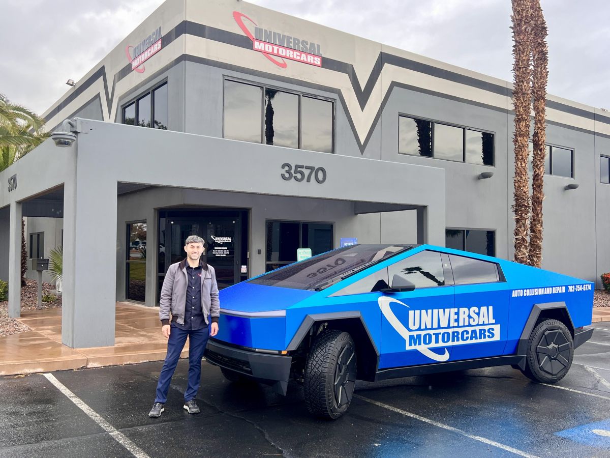 Victor Botnari with Universal’s branded Cybertruck outside the Post Road location, as pictured in Autobody News