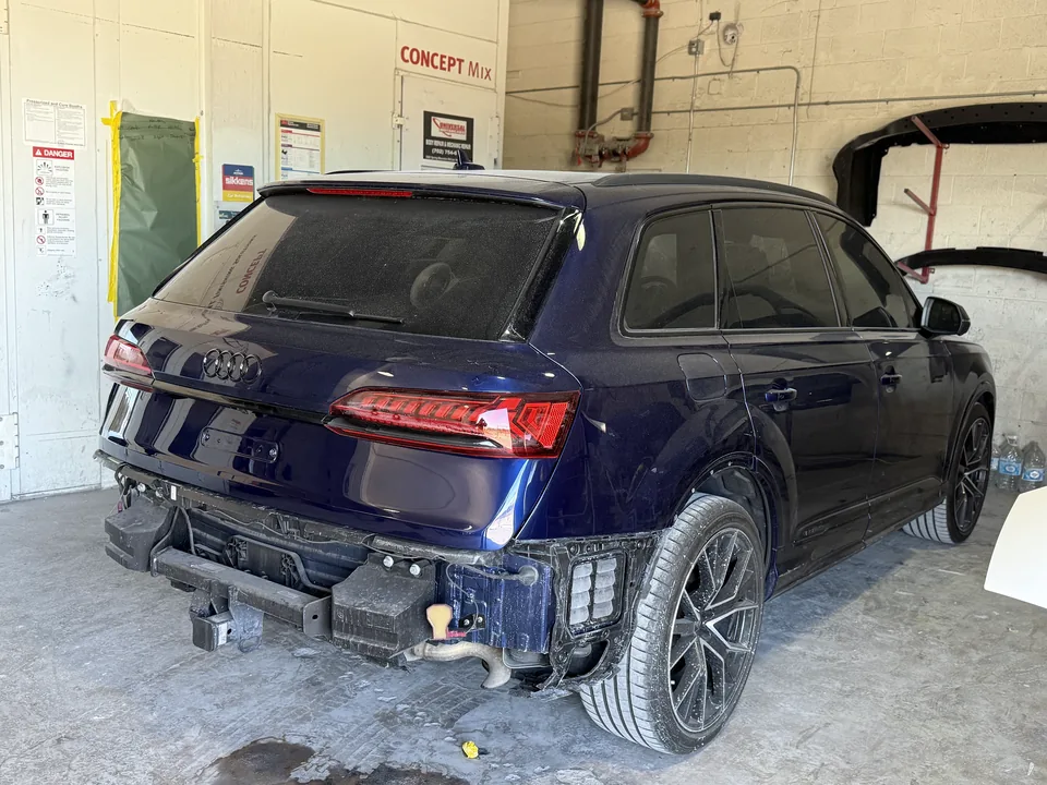Blue Audi SUV in the workshop with its rear bumper removed