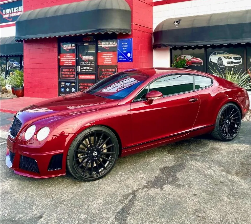 Red Bentley Continental GT outside Universal Motorcars after refinishing