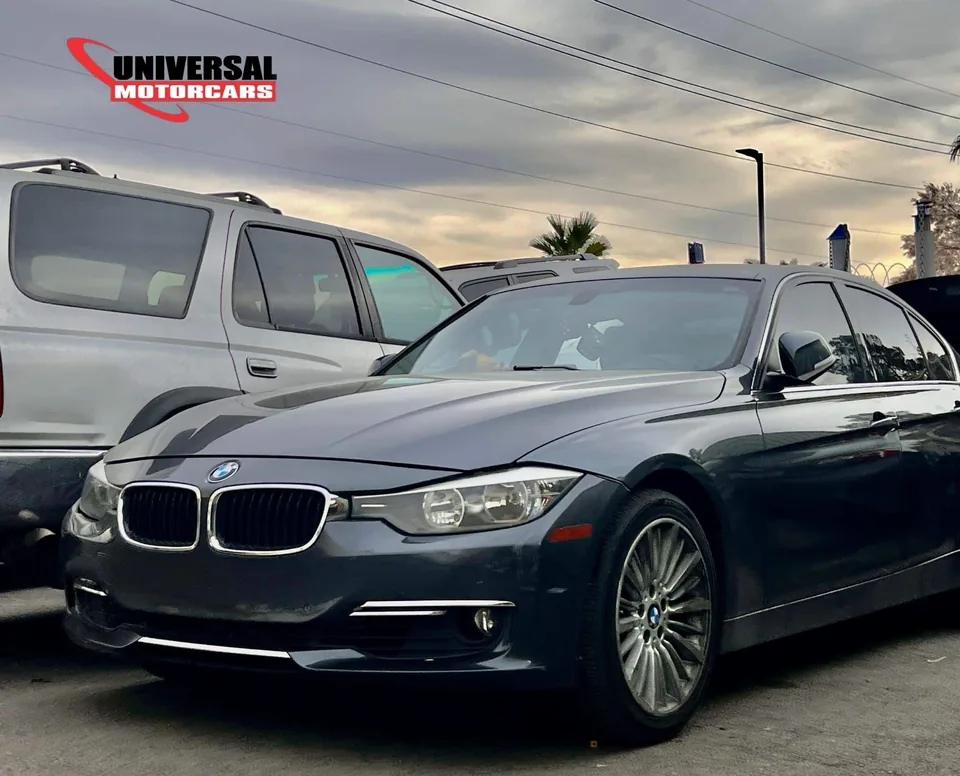 Dark BMW 3 Series sedan outside Universal Motorcars