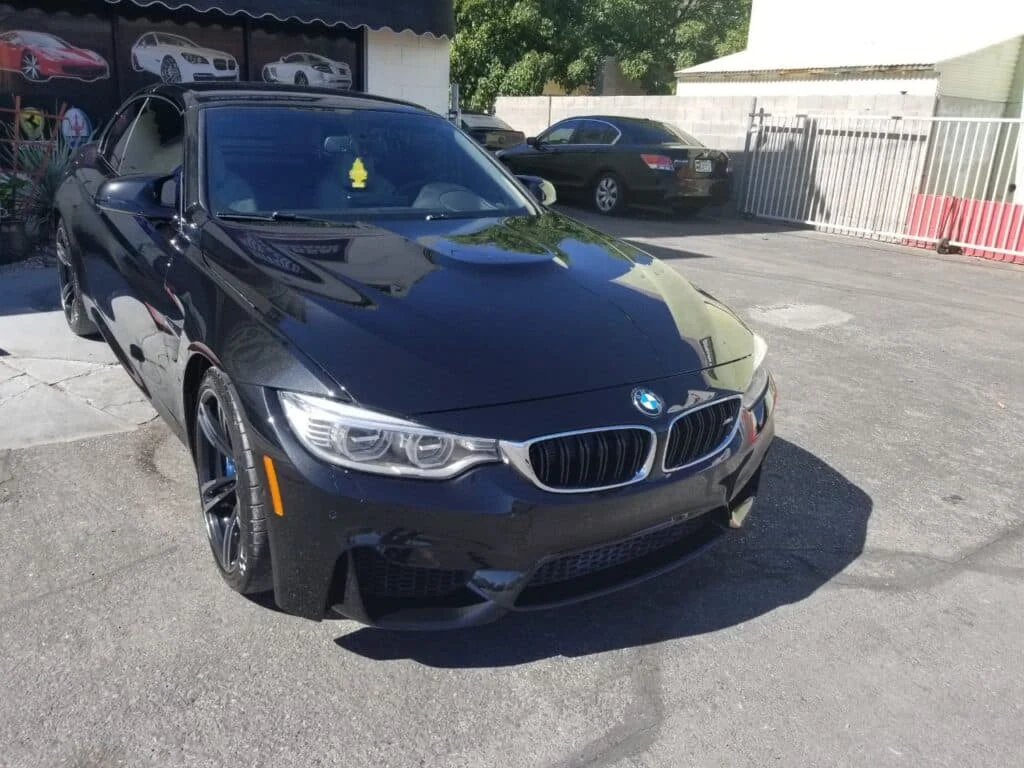 Dark blue BMW with finished front bodywork, hood, bumper and kidney grille