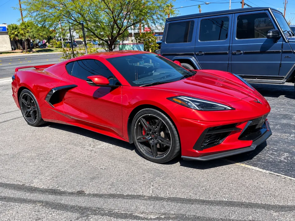 Red Chevrolet Corvette C8, front three-quarter view outside Universal Motorcars