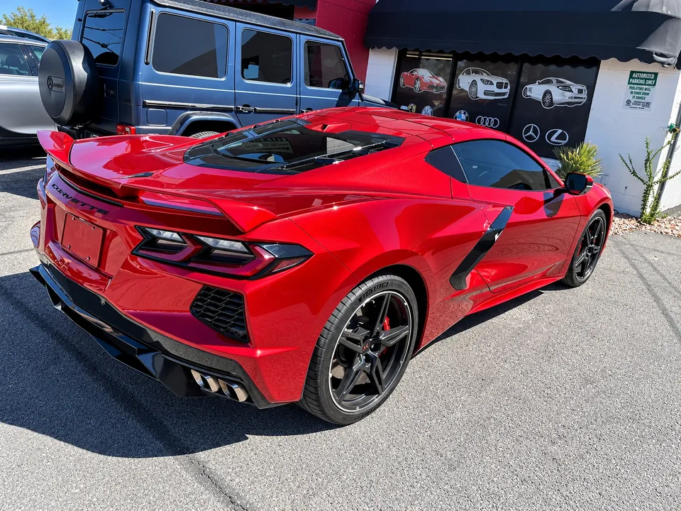 Rear three-quarter view of the same red Chevrolet Corvette C8