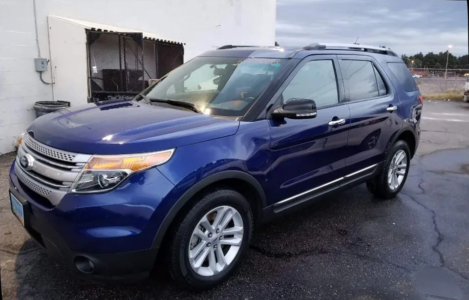 The same blue Ford Explorer with repaired side doors