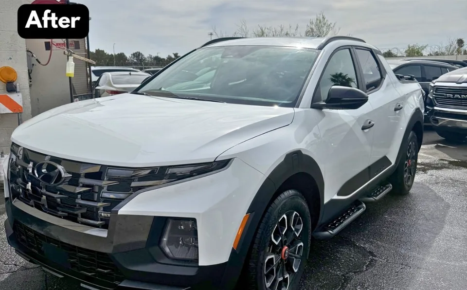 The same white Hyundai Santa Cruz with front bodywork reassembled after repair