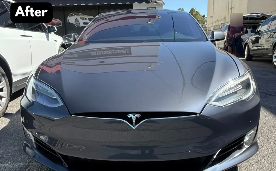 The same gray Tesla Model S with its hood closed and front bumper repaired