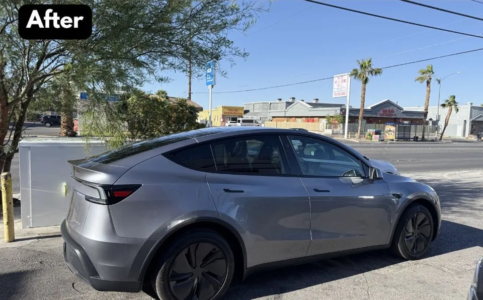 The same gray Tesla Model Y with passenger-side bodywork reassembled after repair