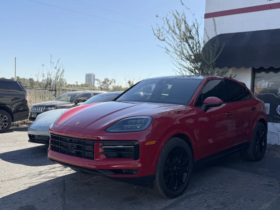 Red Porsche Cayenne outside the Universal Motorcars workshop