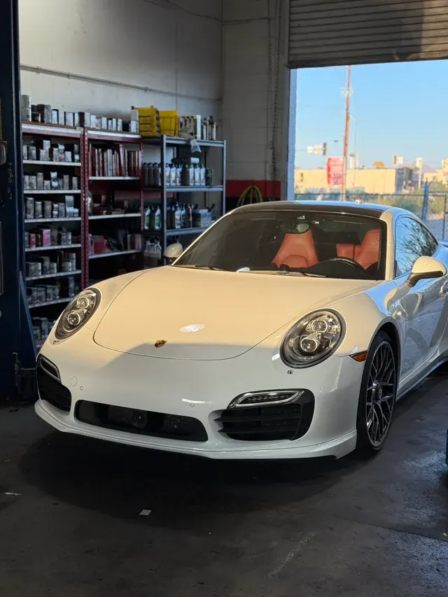 White Porsche 911 front bodywork and bumper in the workshop