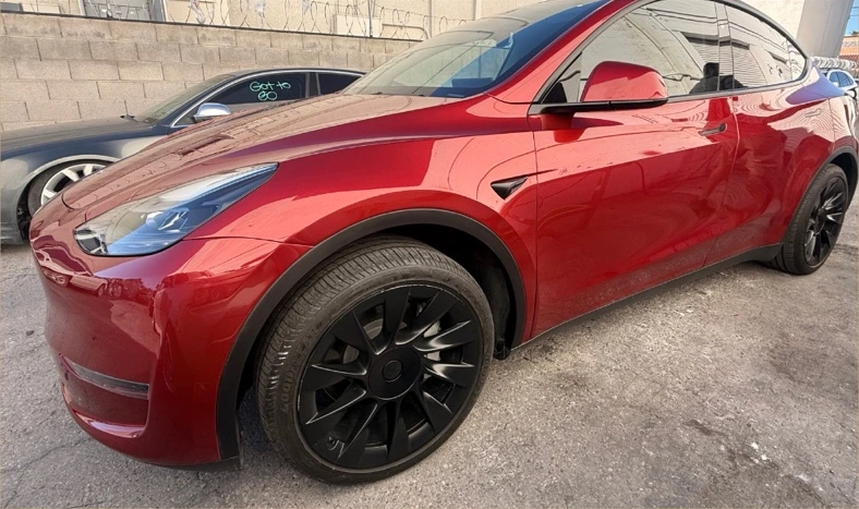 The same red Tesla Model Y after front-corner body and finish repair