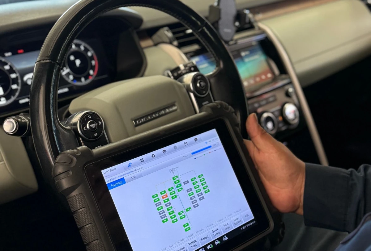 Diagnostic tablet displaying vehicle modules during a scan in a Land Rover at Universal Motorcars