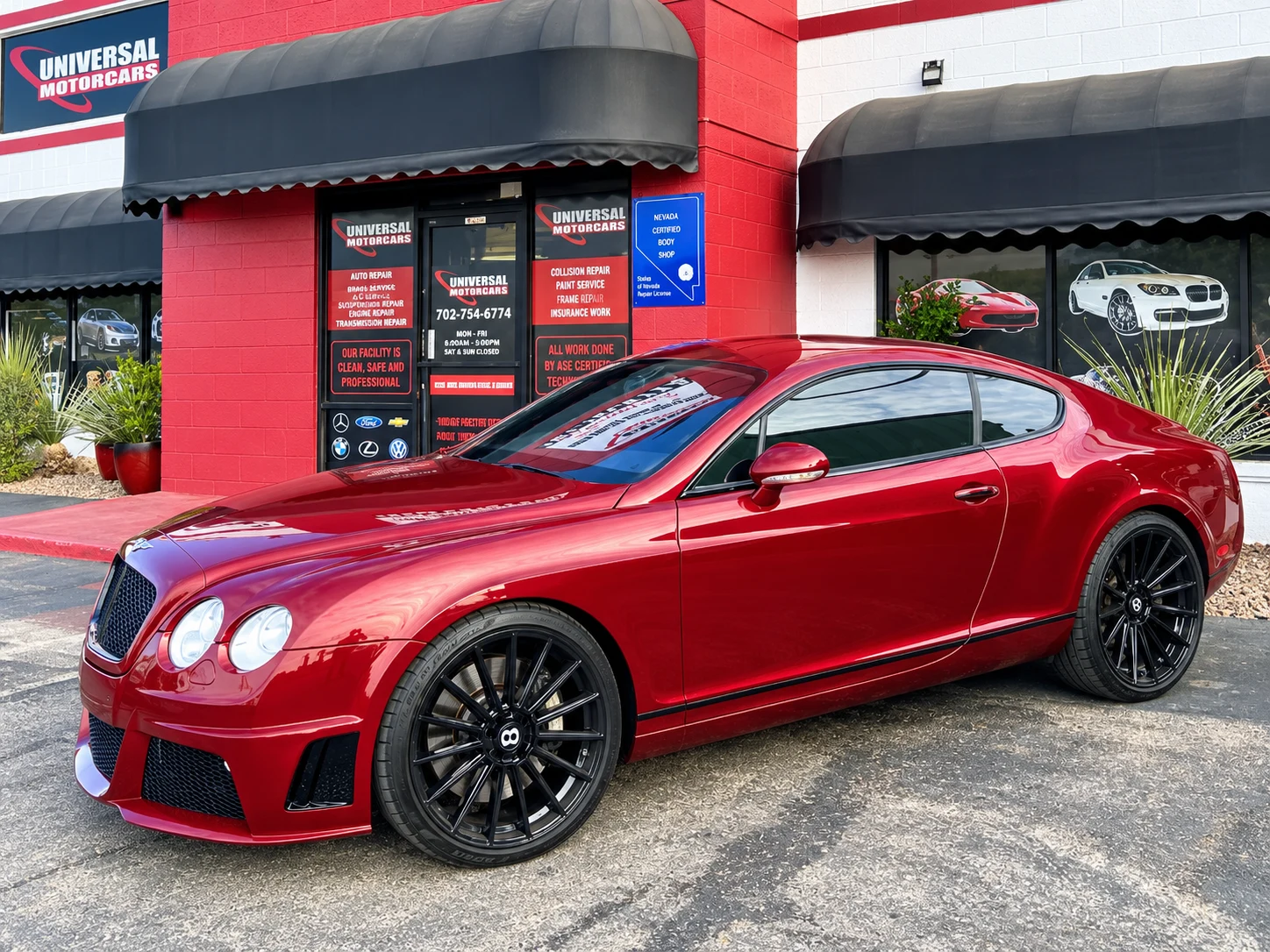 Red Bentley coupe outside Universal Motorcars in Las Vegas, enhanced for clarity.